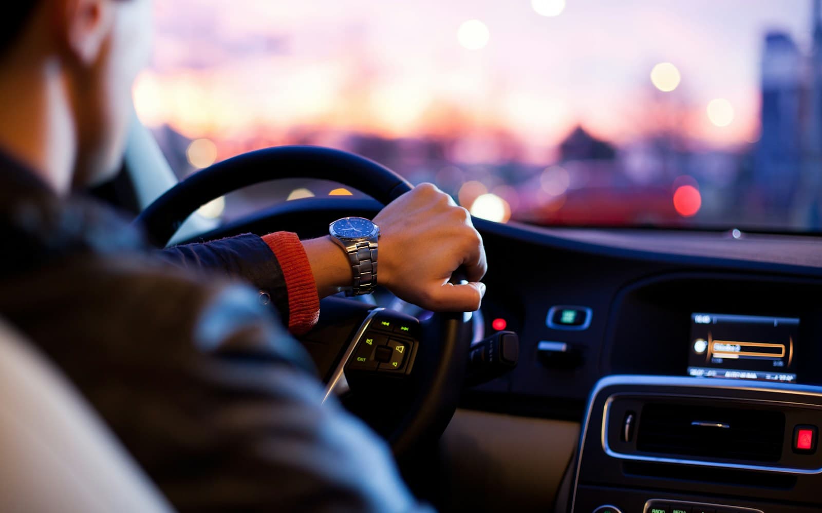 Driving instructor teaching a student in a dual-control car